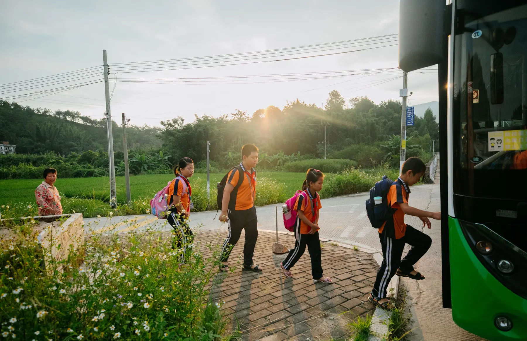 Students with backpacks boarding transportation after school